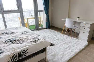 a bedroom with a bed and a desk and a chair at A2J Luxury 3BR Uptown Balcony BGC Suite Near Mall in Manila