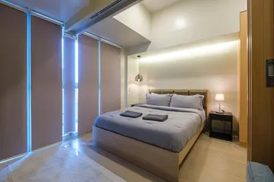 a bedroom with a large bed in a room at Uptown Parksuites Modern Room in Manila