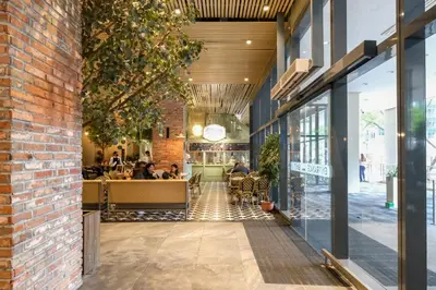 a view of a restaurant with people sitting at tables at Uptown Parksuites Modern Room in Manila