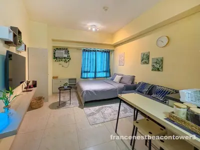 a bedroom with a bed and a couch in a room at Modern Condo Living in Makati in Manila