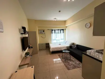 a living room with a couch and a table at Modern Condo Living in Makati in Manila