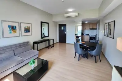a living room with a couch and a table at Spacious BGC 2 BR with a view in Manila