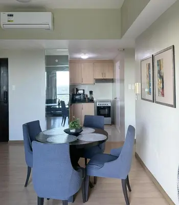 a kitchen and dining room with a table and chairs at Spacious BGC 2 BR with a view in Manila