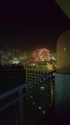 a firework display in the sky over a city at night at 2BR Lower Penthouse @ Acqua Private Residences in Manila