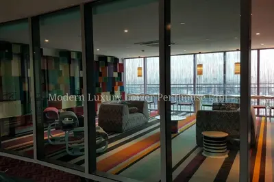 a lobby with glass walls and a room with a couch at 2BR Lower Penthouse @ Acqua Private Residences in Manila