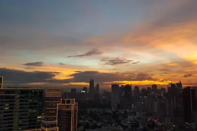 a view of a city skyline at sunset at 2BR Lower Penthouse @ Acqua Private Residences in Manila