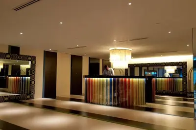 a man standing at a bar in a hotel lobby at 2BR Lower Penthouse @ Acqua Private Residences in Manila