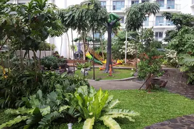 a park with a playground in the middle of a building at 2BR Lower Penthouse @ Acqua Private Residences in Manila