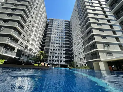 a swimming pool in front of two tall buildings at MOA Shore 3 New Modern One bedroom Condo in Manila