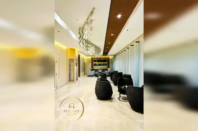 a lobby with couches and a television in a room at MOA Shore 3 New Modern One bedroom Condo in Manila