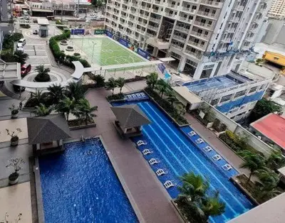 an overhead view of two swimming pools in a city at Lumiere suites in Manila