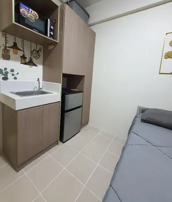 a bathroom with a sink and a bed in a room at Urban Deca Shaw EDSA Mandaluyong in Manila