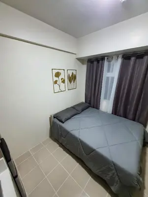 a bedroom with a bed in a room at Urban Deca Shaw EDSA Mandaluyong in Manila