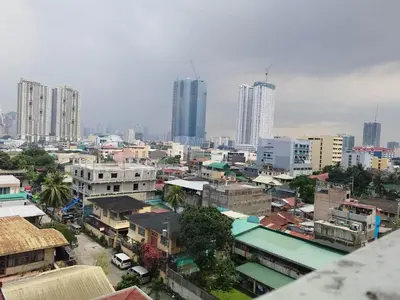 a city skyline with tall buildings in a city at SMDC Breeze Residences in Manila