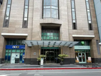 a building on the corner of a city street at Fabulous Skyline KL Greenbelt Makati in Manila