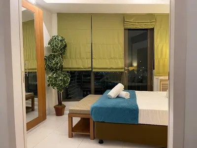 a bedroom with a bed and a large window at Fabulous Skyline KL Greenbelt Makati in Manila