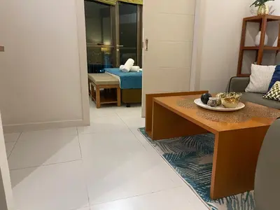 a living room with a couch and a table at Fabulous Skyline KL Greenbelt Makati in Manila