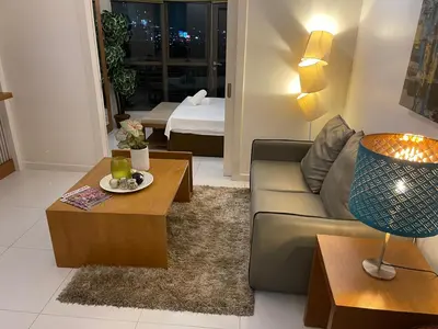a living room with a couch and a table at Lux Skyline KL Greenbelt, Isabel's Makati Rooms in Manila