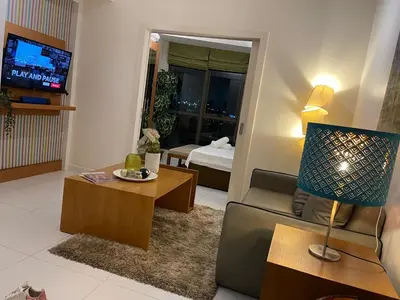 a living room with a couch and a table at Lux Skyline KL Greenbelt, Isabel's Makati Rooms in Manila