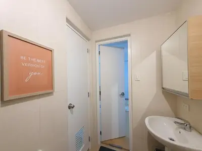 a bathroom with a sink and a mirror at Avant in BGC - Spacious 1 Bedroom with Amazing View in Manila
