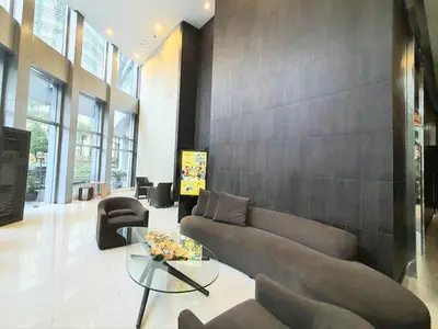 a living room with a couch and a glass table at Avant in BGC - Spacious 1 Bedroom with Amazing View in Manila