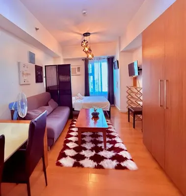 a living room with a couch and a table at Cozy Condo in Ermita Manila near St Lukes Medical Center and US Embassy in Manila