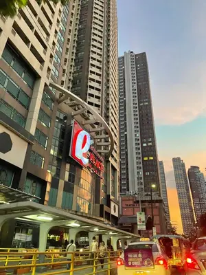 a city with cars on a street with tall buildings at 1 Bedroom Bayview Condo near SLMEC & US Embassy in Manila