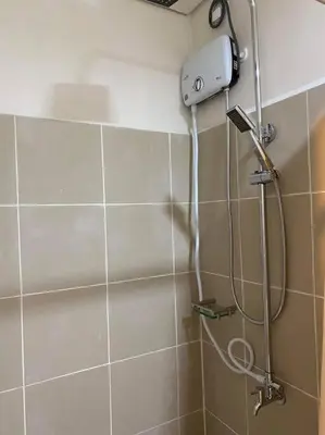a shower in a bathroom with a shower head at SMDC Coast Residences Condo near MOA, CCP, PICC, Star City in Manila