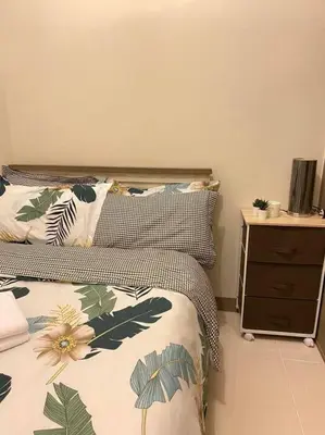 a bedroom with a bed and a night stand at SMDC Coast Residences Condo near MOA, CCP, PICC, Star City in Manila
