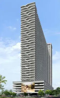 a tall building with a billboard in front of it at SMDC Coast Residences Condo near MOA, CCP, PICC, Star City in Manila
