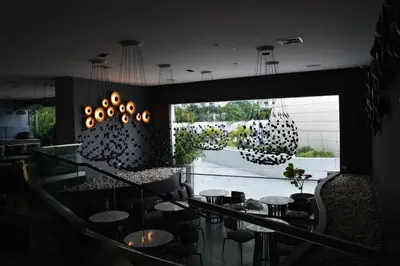 a dining room with a glass table and chairs at Luxxe interior design condo - Residences at Acqua private residences in Manila