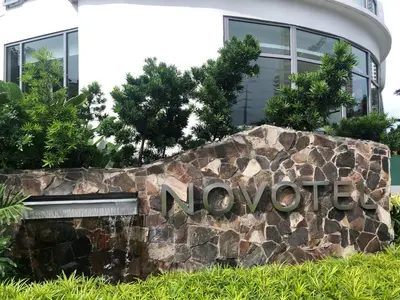 a sign for a hotel in front of a building at Luxxe interior design condo - Residences at Acqua private residences in Manila