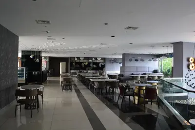 a restaurant with tables and chairs in a room at Luxxe interior design condo - Residences at Acqua private residences in Manila