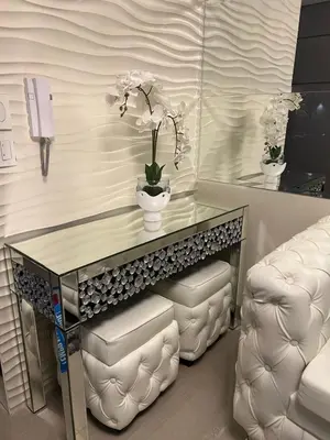 a table and chairs in a room with a phone at MiamiViceLuxuryStays at Shore2 in Manila