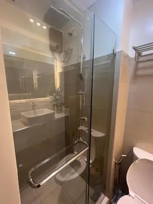 a bathroom with a shower and a toilet and a sink at MiamiViceLuxuryStays at Shore2 in Manila
