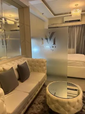 a living room with a couch and a bed at MiamiViceLuxuryStays at Shore2 in Manila