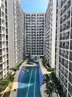 an overhead view of a pool between two tall buildings at MiamiViceLuxuryStays at Shore2 in Manila