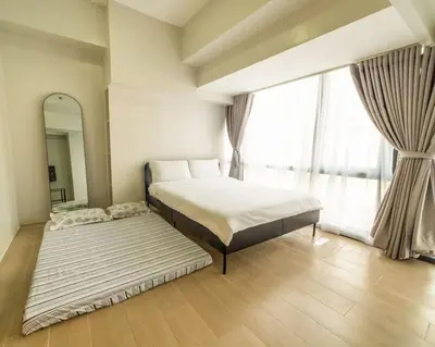 a bedroom with a bed and a large window at StayHere Skandanavian Designed 1BR in Greenbelt in Manila
