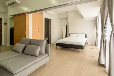 a living room with a couch and a bed at StayHere Skandanavian Designed 1BR in Greenbelt in Manila