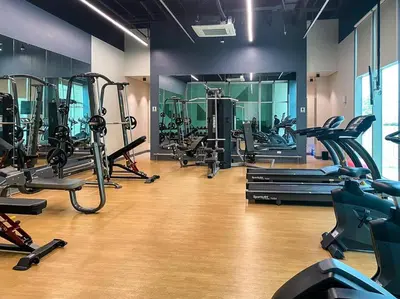 a gym with a bunch of treadms and machines at Modern and homely Condo in Shaw Boulevard in Manila