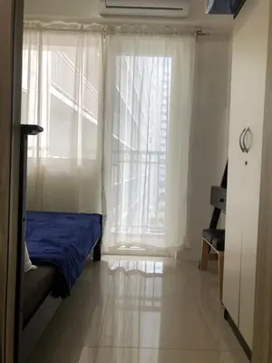 a bedroom with a bed and a large window at Home at Last, 1 Bedroom Pool View with Balcony in Manila