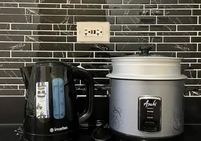 a coffee maker and a tea kettle on a counter at Victoria Suite at Shore Residences in Manila