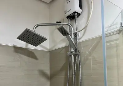 a shower with a shower head in a bathroom at Victoria Suite at Shore Residences in Manila