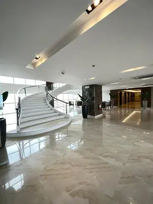 a lobby with a staircase in a building at Chen's Cozy 2bedroom @ Coast Residences in Manila