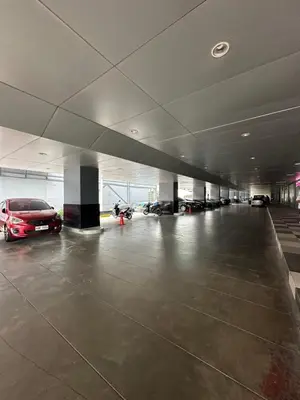 a large parking garage with cars parked in it at Chen's Cozy 2bedroom @ Coast Residences in Manila
