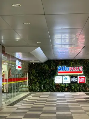 an entrance to a shopping mall with a green wall at Chen's Cozy 2bedroom @ Coast Residences in Manila