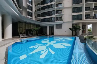 a large swimming pool in the middle of a building at StayHere The Florence Luxe 1BR Near Venice Mall in Manila