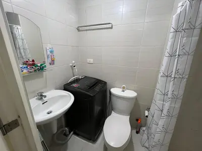 a small bathroom with a toilet and a sink at Jazz Residences Makati in Manila