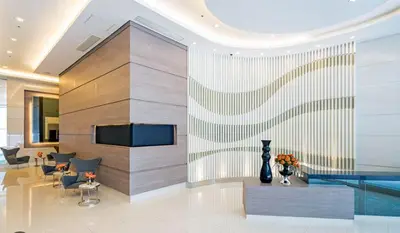 a lobby with a pool in a building at Jazz Residences Makati in Manila