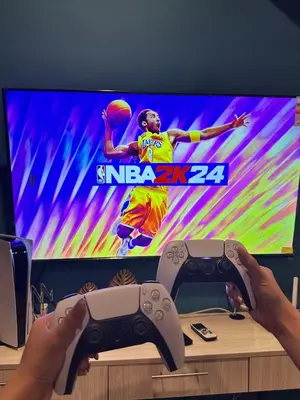a person holding a video game controller in front of a tv at Cozy Spacious Hotel Type Condo with PS5 Smart TV and WiFi in Manila
